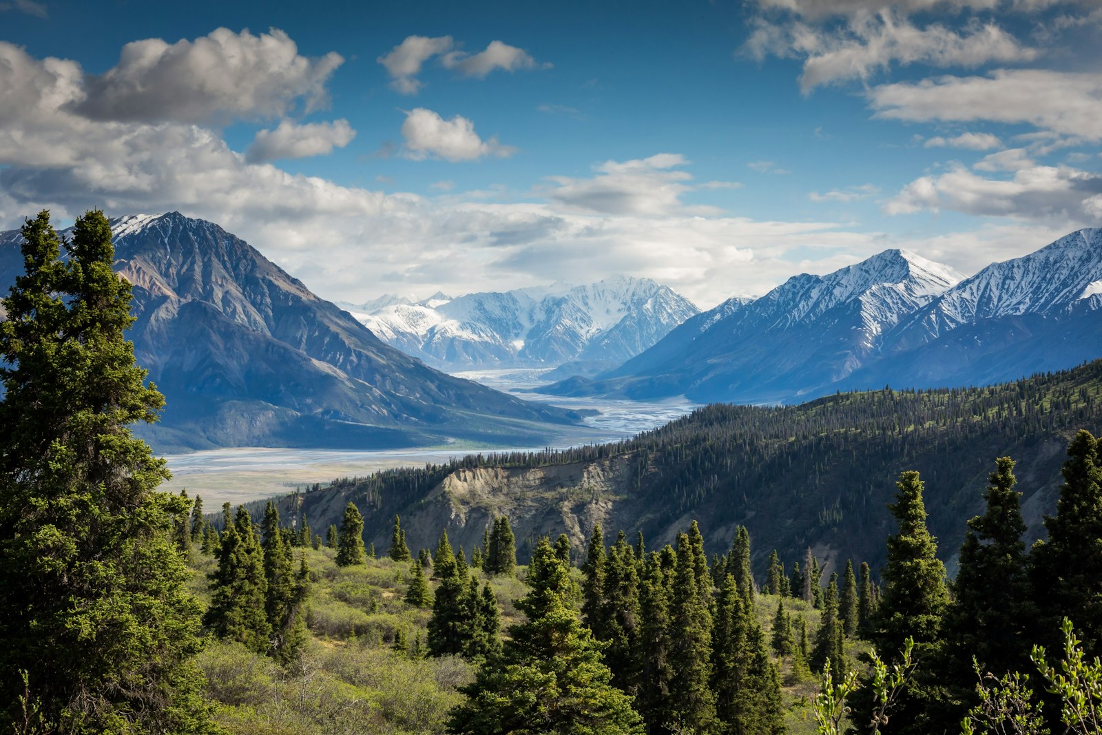 Wide high valley with steep slopes and low drifting clouds